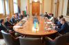 All the participants of the meeting during their discussion, sitting at a conference table in the Curia’s Mailáth Room.