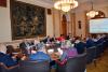 All the participants of the seminar during their discussion, sitting at a conference table in the Curia’s Mailáth Room.